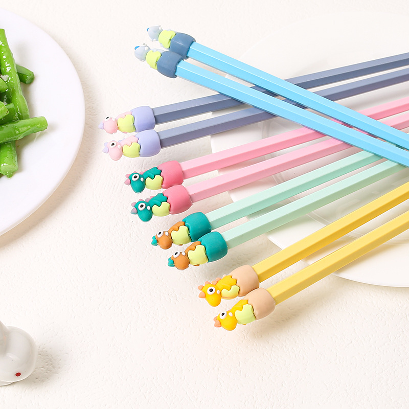 Lindos palillos de aleación de dibujos animados al por mayor Macarons de alto valor cabeza de dinosaurio comida separada una persona palillos al por mayor