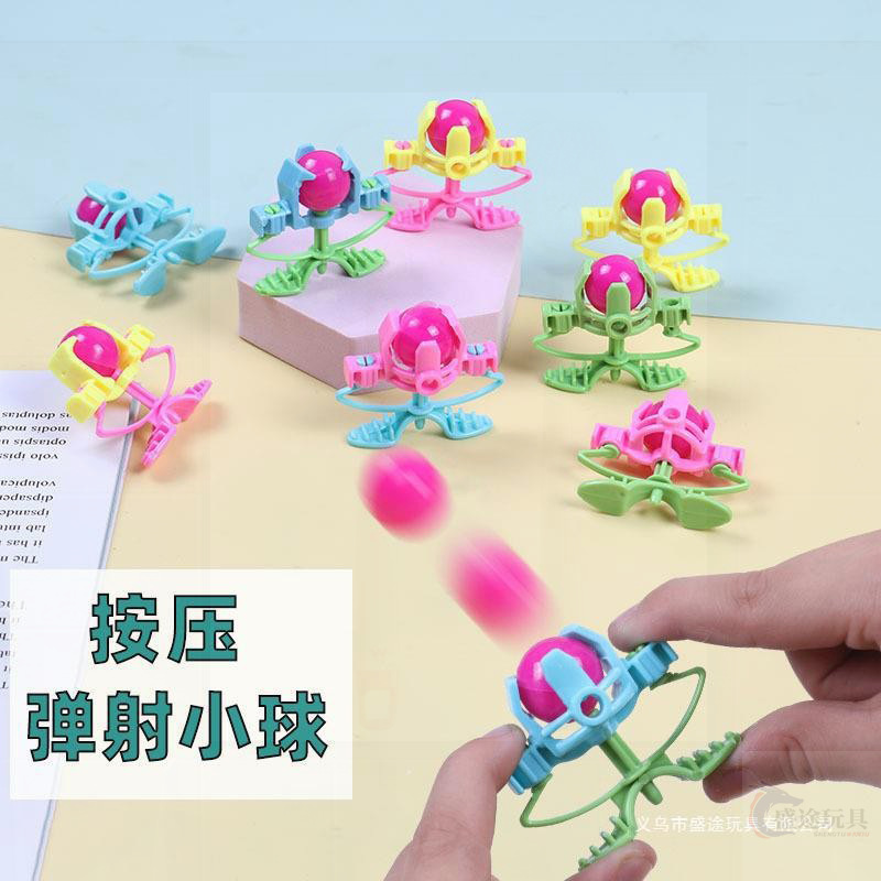 Candy-colored bouncing ball toy for kids – vibrant, solid-color plastic shooter with cartoon designs, perfect for party fun and play.