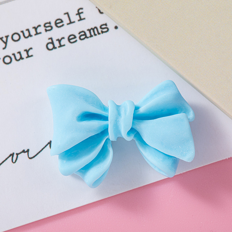 Accesorios de resina de arco de color macaron DIY Crema Accesorios de cuerda de cabello de agujero de caja de teléfono móvil Colgante de hebilla de zapato