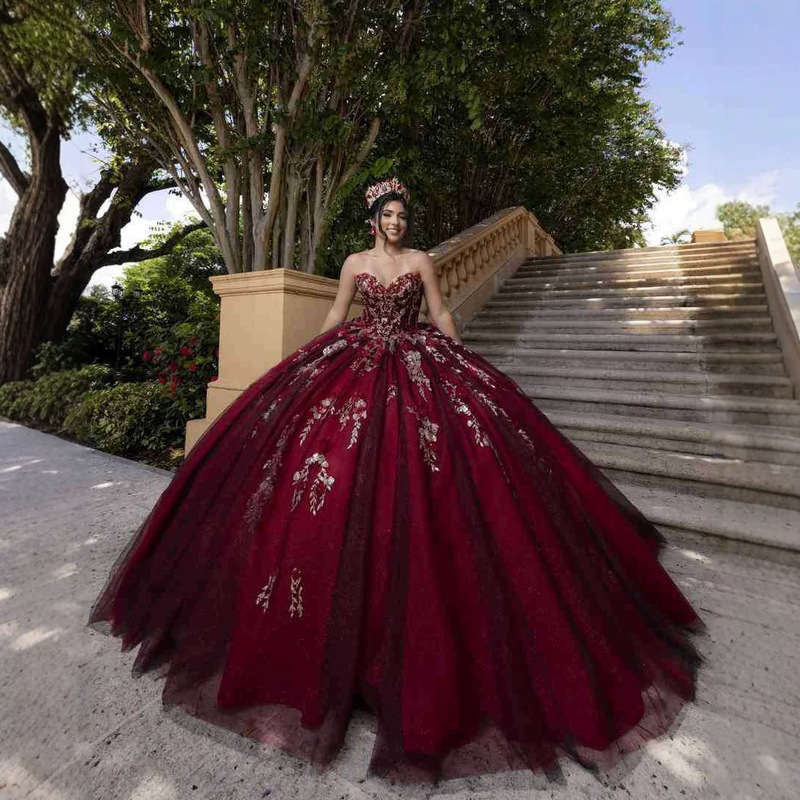 Burgundy strapless dress with elaborate embroidery, glittery mesh, and a fluffy princess skirt for adult ceremonies and balls, offering an ethereal and sophisticated look