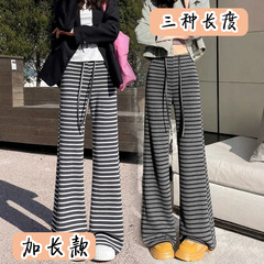 黒のストライプの小さいラッパのズボンの女子学生は春の新型のハイウエストを延長して痩せています。