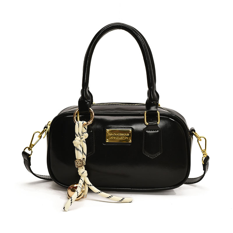 Bolsa de bolos de mano caliente para mujeres 2025, nueva bolsa de hombro simple de moda popular, bolso de mochila de estilo extranjero