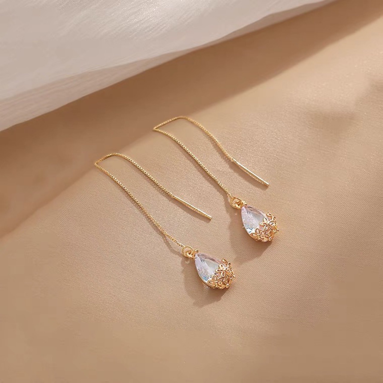 White elegant women's earrings with zircon drop-shaped with tassels