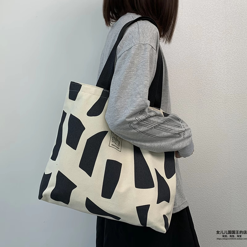 Bolsa de lona para mujeres en clase de estudiantes universitarios envueltos de libros coreanos con cremallera nicho de diseño sensación de hombro bolsa de lona portátil