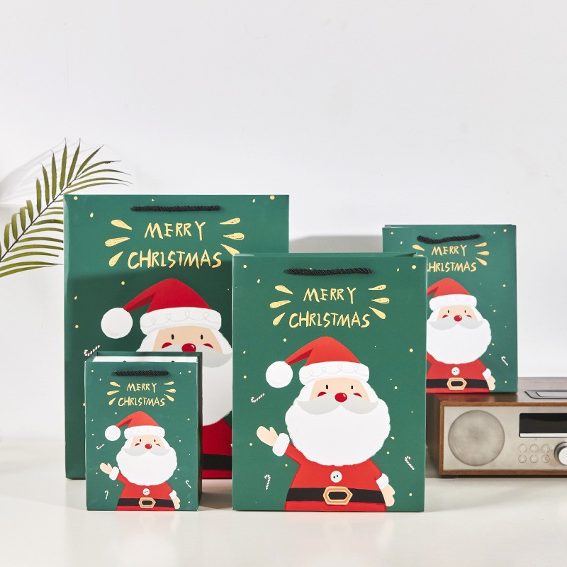 En stock bolsa de regalo de Navidad Nochebuena bolso de cartón blanco de alto sentido bolsa de regalo de dibujos animados directo de fábrica al por mayor