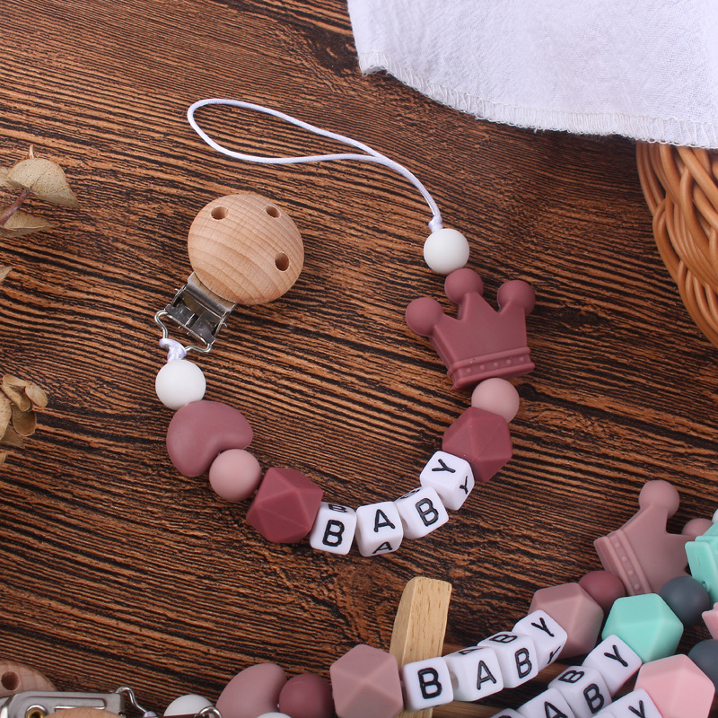 Nuevo bebé haya chupete clip calmante bebé corazón corona de silicona mordedura molar Cadena de chupete cadena anti-caída