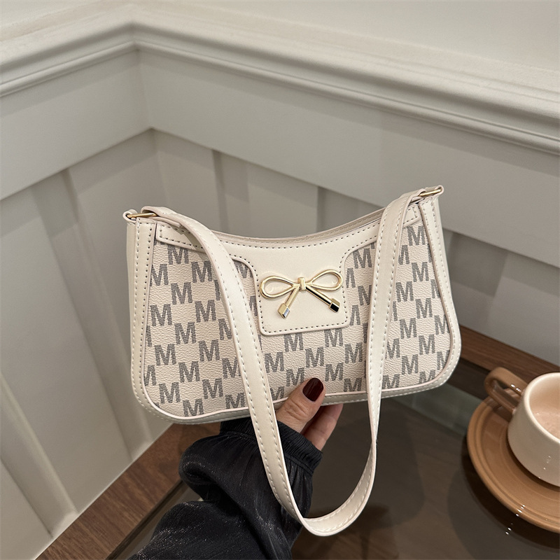 Cosmetía coreana estilo de moda textura arco de moda primavera 2025 nuevo estilo extranjero de viaje brazo bolso de hombro para mujeres