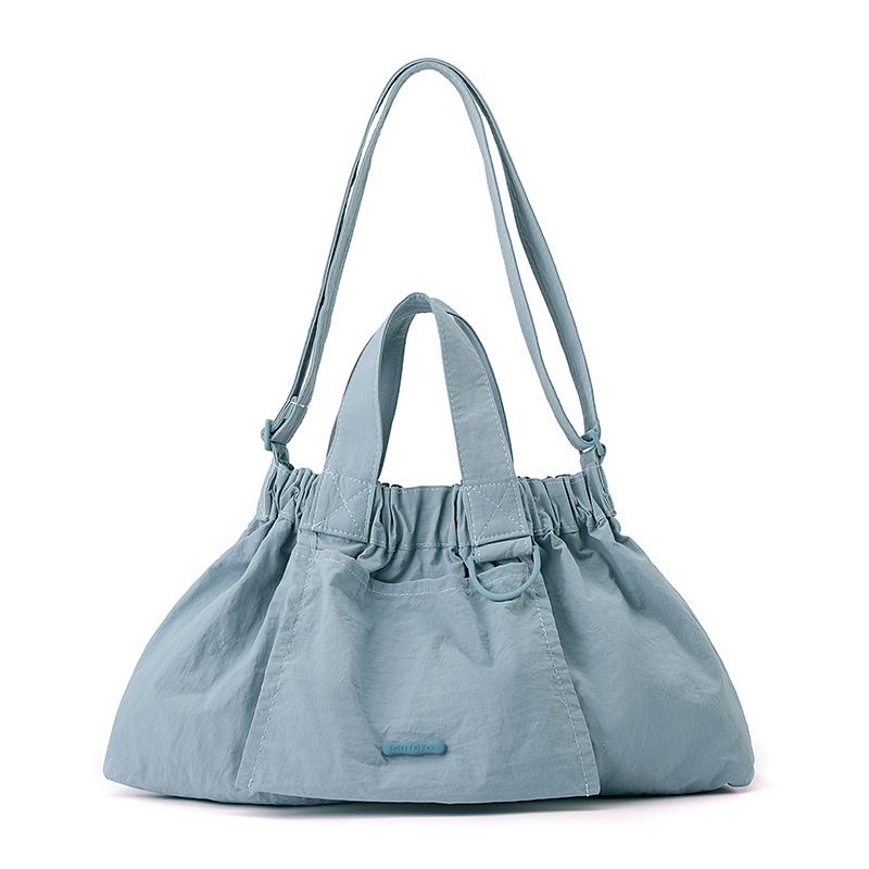 El nuevo diseño de nicho coreano del comercio exterior tiene un sentido del conocimiento de embarque a mano y una bolsa de mujer en el hombro es ligera, casual y plegable.