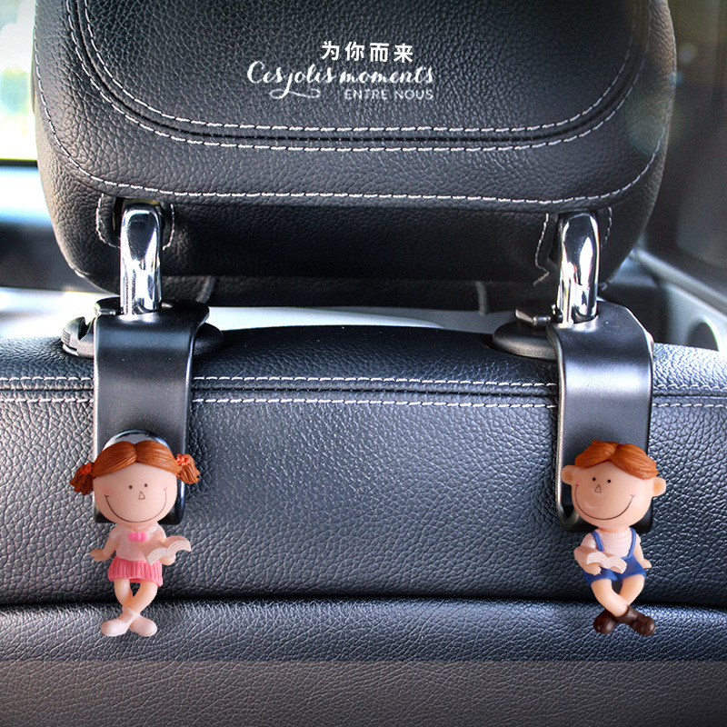 Accesorios interiores de automóviles transfronterizos gancho trasero gancho de asiento de automóvil pareja encantadora lectura de dibujos animados muñeca popularidad en línea