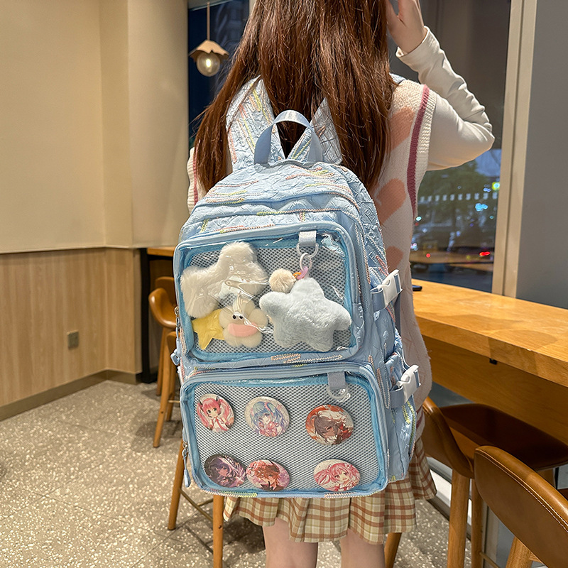 En la nueva mochila femenina 2025, la nueva chica tiene una gran capacidad de dibujos animados, estudiantes de secundaria, mochilas llenas de bolsos portátiles.