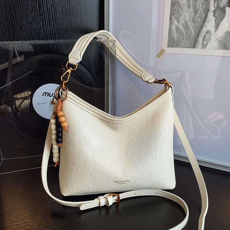 Nicho de alta sensación bolso de cuero suave para mujeres 2025 nueva moda versátil mochila de hombro mochila de viaje