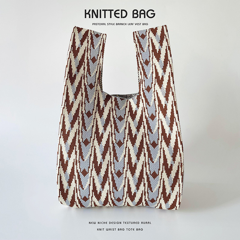 Bolsa de diseño de nicho de punto bolso de hombro bolso de mano simple de gama alta todo-fósforo de gran capacidad estudiante bolso de la muñeca