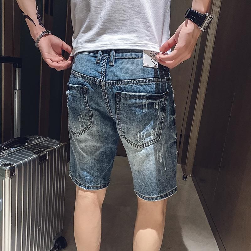 Summer spirit young man's ripped denim s...