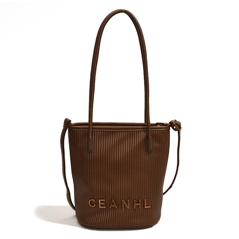 2025 otoño y invierno nuevo pequeño bolso a rayas de viento fragante bolso de cubo simple bolso de hombro de tendencia de mujeres bolso de mochila popular