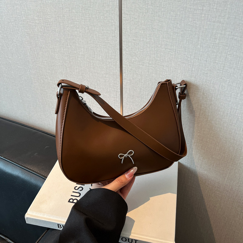 Nueva moda bolsa de color sólido textura 2025 casual bowknot bola de masa bolsa de axila de un solo hombro bolsa de media luna negro