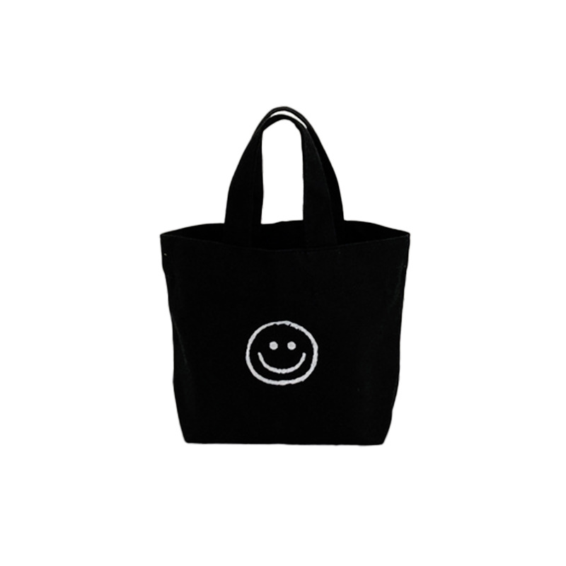 캔버스 가방 여성의 2023 새로운 휴대용 웃는 가방 캐주얼 대학 스타일 학생 작업 올 매치