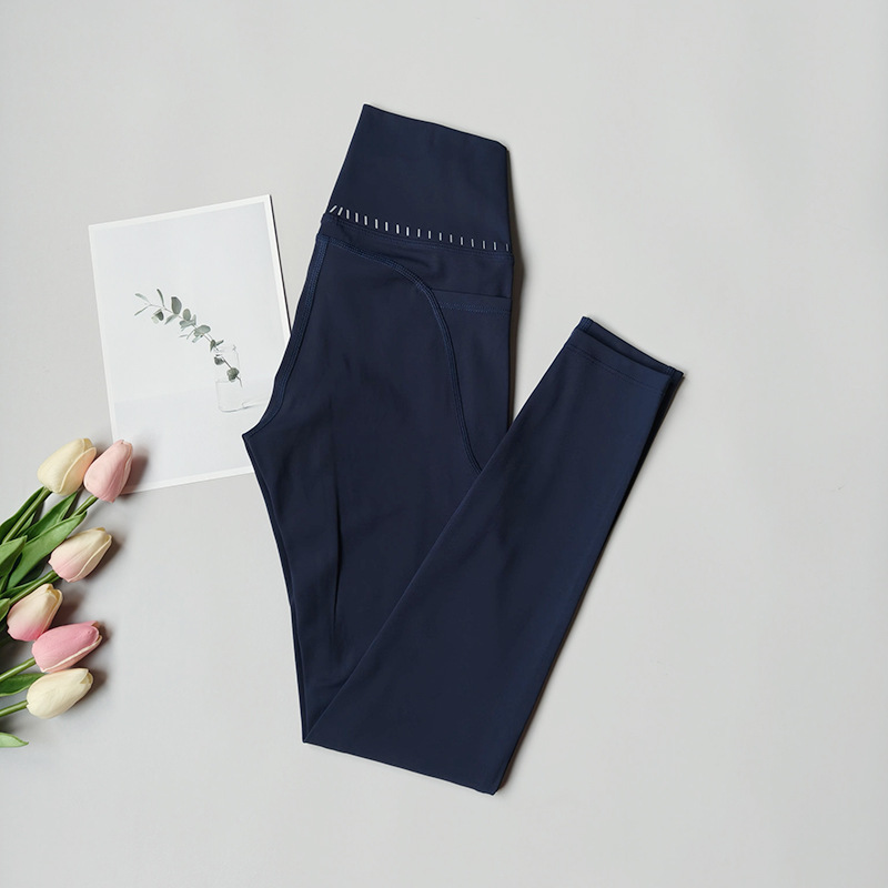 Pantalones de fitness desnudos para mujeres sonrientes líneas de elevación de cadera pantalones deportivos para mujeres al aire libre cintura alta sin marcas nueve puntos pantalones de calzado