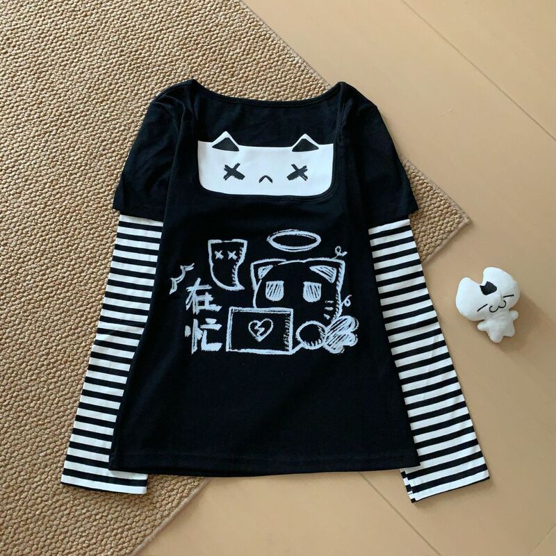 Japanese-style, minimalist, two-piece look long-sleeved black and white striped patchwork T-shirt with cartoon cat graffiti, a sweet and cool girl's top