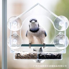 A large acrylic bird feeder with a cute and creative simple plastic transparent pet bird feeder