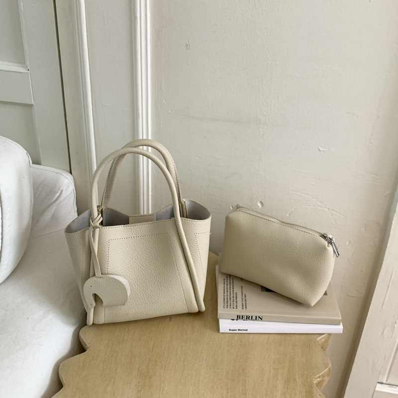 Bolso para mujeres 2026 nuevo estilo de moda bolso de cubo portátil de alta calidad lichi patrón popular lujo ligero mochila casual