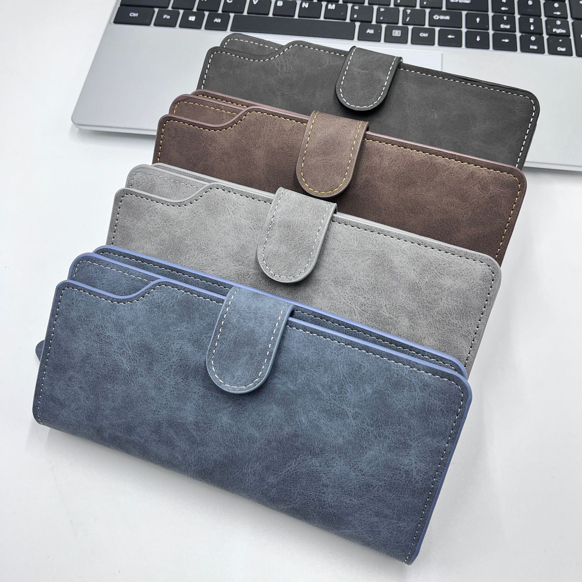 Long men's wallet with multiple card slots, a large-capacity, multi-functional business handbag, and a zippered phone pouch