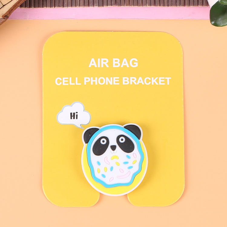 En stock al por mayor TikTok Cartoon creativo soporte de teléfono móvil puede soportar airbag soporte de teléfono móvil soporte de escritorio