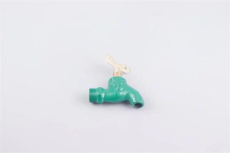 Old-fashioned iron faucet with a slow opening time of 4 minutes or 6 minutes and a fast opening time. It is a copper core flat spout cast iron faucet with a key at an outdoor construction site undefined