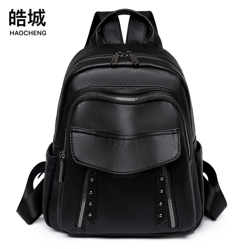 Comercio exterior al por mayor 2023 nuevo estilo coreano señoras PU mochila moda remache retro gran capacidad mochila de viaje marea