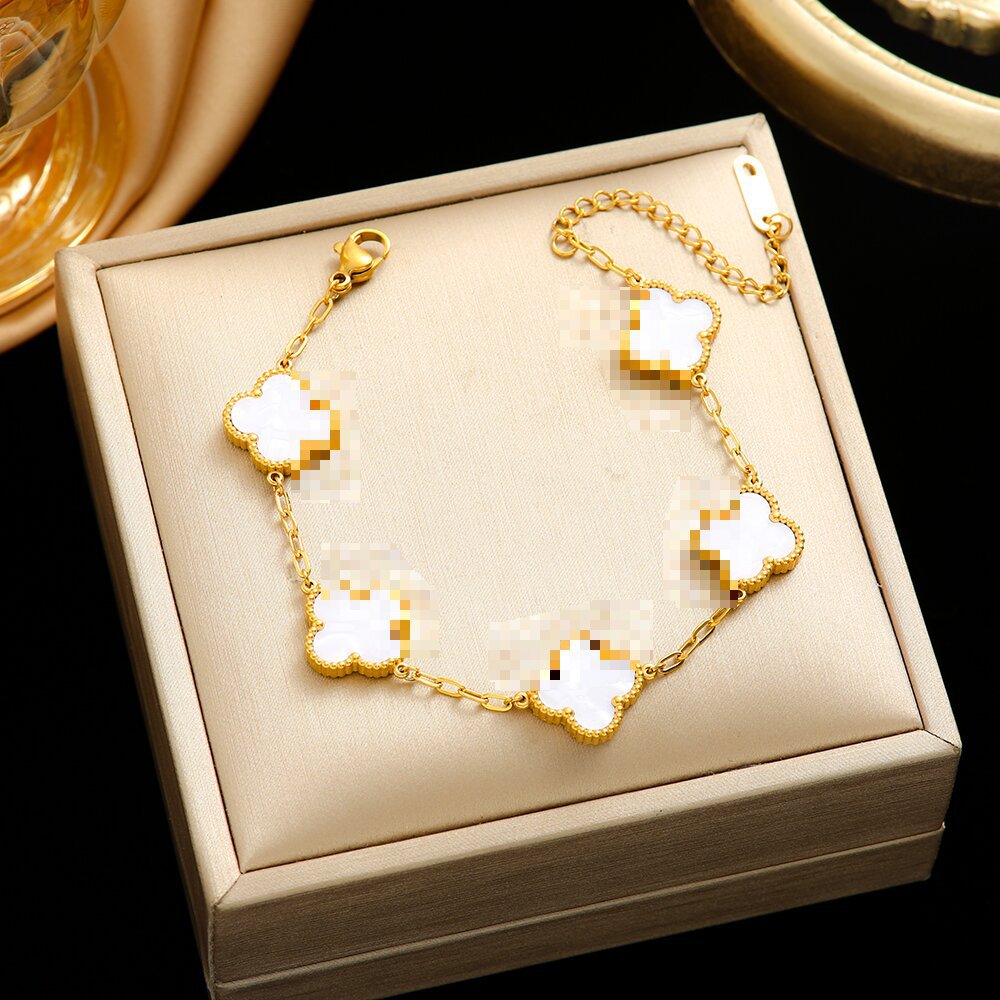 Pulsera de trébol de acero titanium vendedora caliente transfronteriza europea y americana con incrustaciones de concha pulsera colgante pulsera de diseño avanzado sin desvanecimiento al por mayor