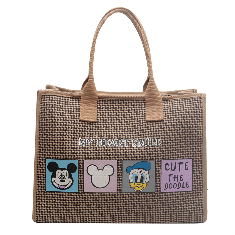 Bolso de mujer de alta sensación 2025 nuevo lienzo simple impresión de gran capacidad bolso de mano bolso de hombro de caricatura mamá
