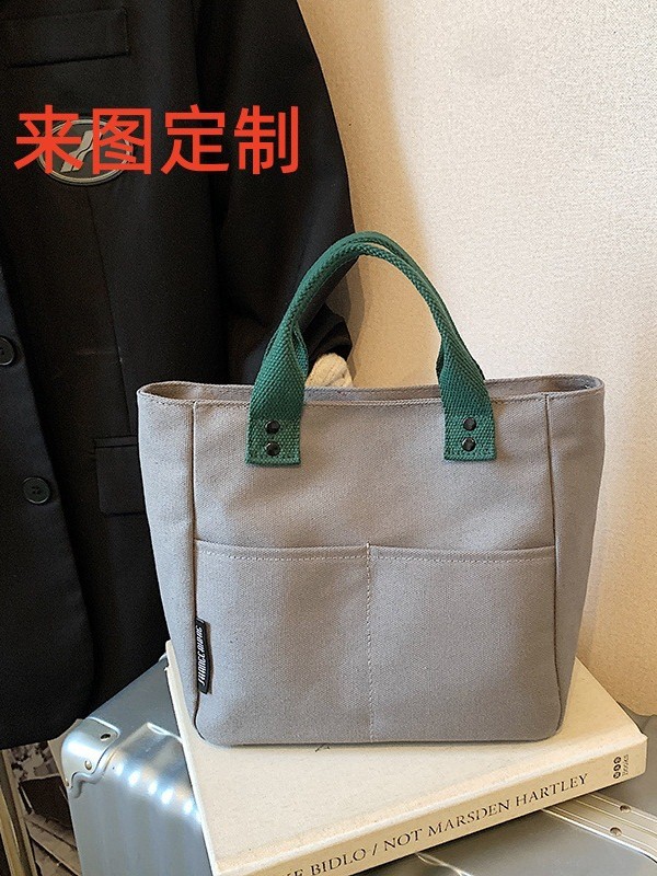 Bolsa de mujer 2026 nuevo bolso de lona de viaje multibolsillo bolso de bolsa de publicidad logotipo impresa en stock