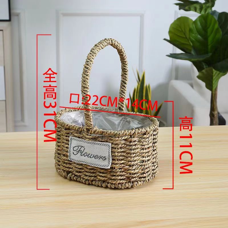 Fabricantes de cestas de flores ovales rectas de paja hechas a mano en stock al por mayor cestas de flores de paja portátiles decoración de viento pastoral