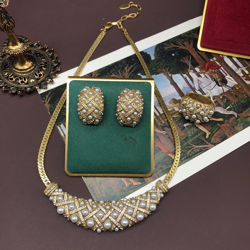 Vintage Western jewelry set: distressed gold, pearl, and rhinestone inlaid short necklace, earrings, and ring.