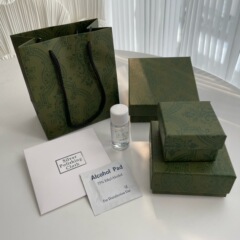 A gift box for a disposable jewelry set, including a ring, necklace, and accessories, along with silver polishing cloth, silver polishing stick, and alcohol cotton pads.