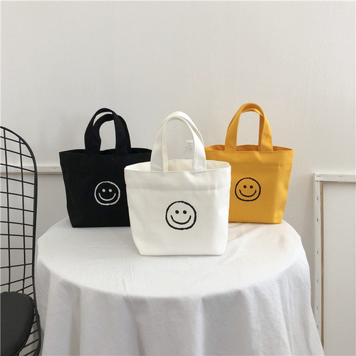 Korean Version 2025 New Smiling Face Ins Style Super Hot Canvas Bag for Girls Students Bento Mini Handbag Wholesale