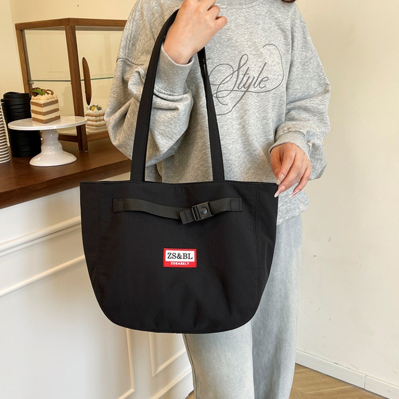 Bolso de letras coreanas 2025 verano nuevo bolso femenino bolso de lona para estudiantes bolso de hombro casual de gran capacidad