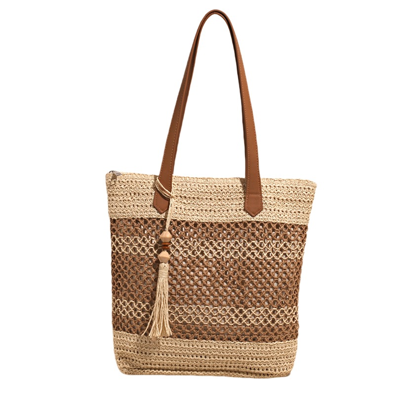 2025 nuevo bolso de cubo portátil de tendencia a cuadros, bolso de paja hueco de vacaciones junto al mar, bolso de hombro de playa de gran capacidad