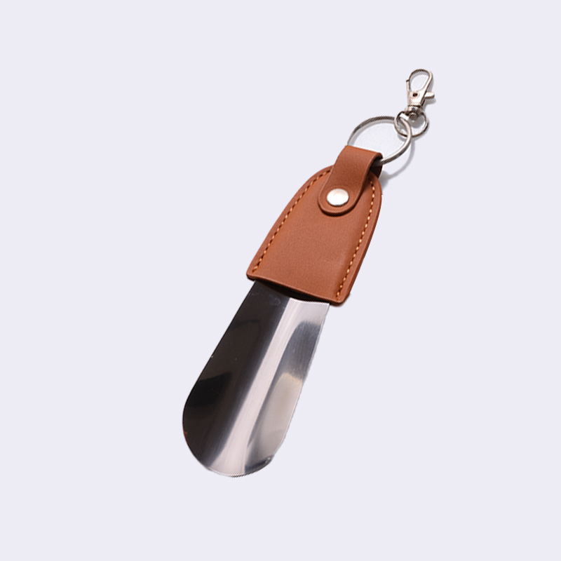 En stock suministro de acero inoxidable hebilla de llave tirador de zapatos con cubierta de cuero tirador de zapatos llave del coche colgante fácil de llevar levantador de zapatos
