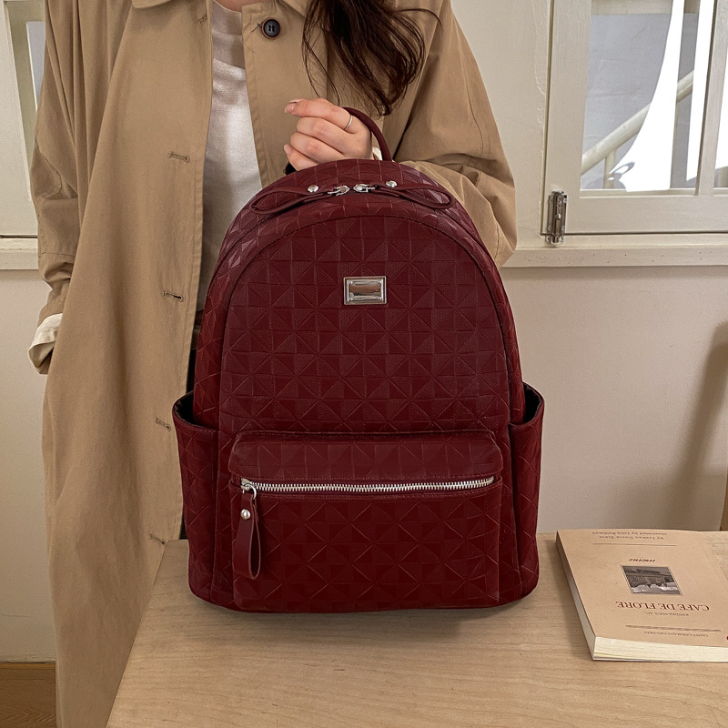 Mochila de moda coreana en relieve para mujeres simple color sólido mochila de viaje de gran capacidad 2026 nueva bolsa de mujer transfronteriza