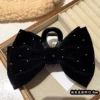 Black crab pin with bow