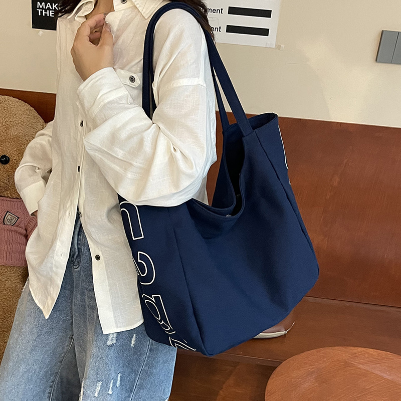 Bolso Tote de moda coreana 2025 verano nuevo estilo bolso femenino casual alfabeto bolso de hombro de lona estilo universitario