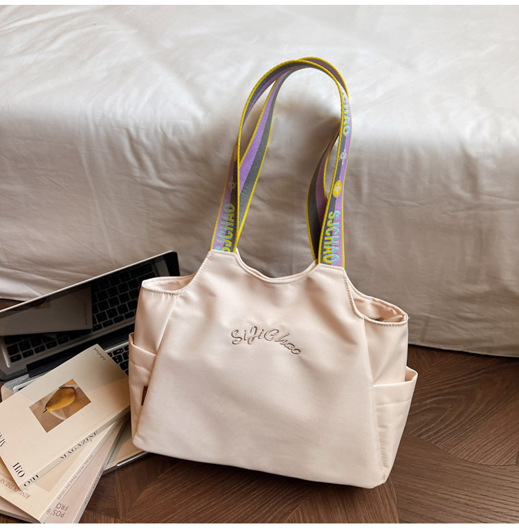 Bolsas de lona de moda de gran capacidad para mujeres 2026 nueva textura bordada letras bolsas de hombro de viaje simple bolsas de mano