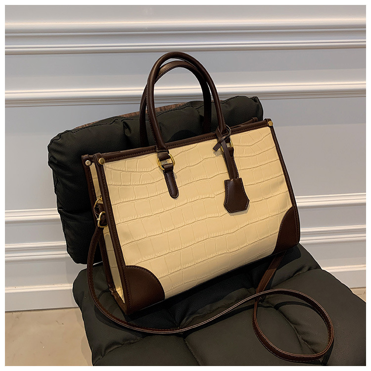 Bolso Tote portátil transfronterizo de gran capacidad para mujer 2025 nuevo modelo retro patrón de piedra contraste bolso de mensajero de hombro de viajero