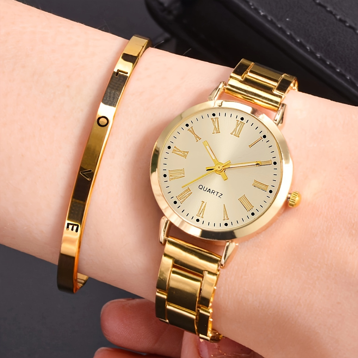 Gold single watch with roman numeral dial + bracelet