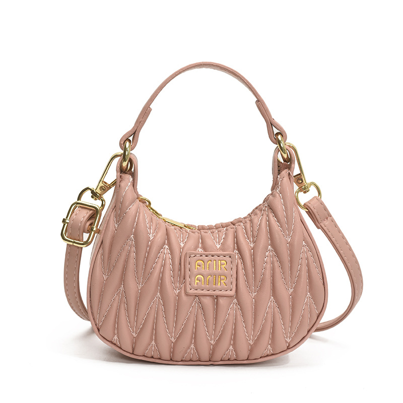 Versión coreana del bolso de hombro de niña de color sólido simple estilo occidental mini bolso de la axila portátil del bebé nuevo bolso de los niños plisado