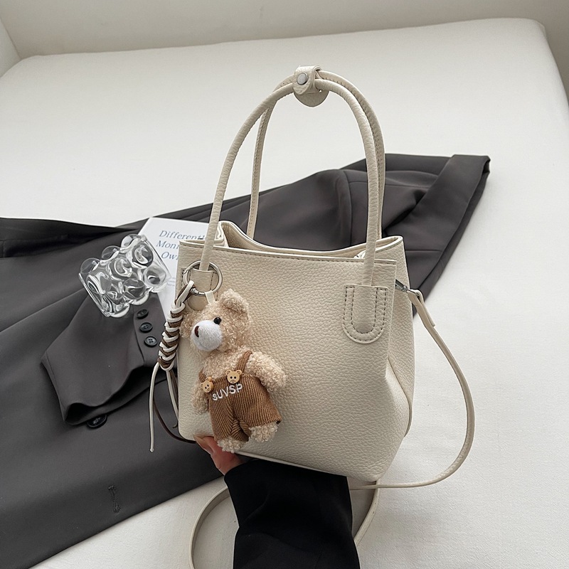 Bolso de cubo portátil de moda coreana para mujer 2025 primavera y verano nuevo bolso de mensajero de un solo hombro casual de alta gama simple