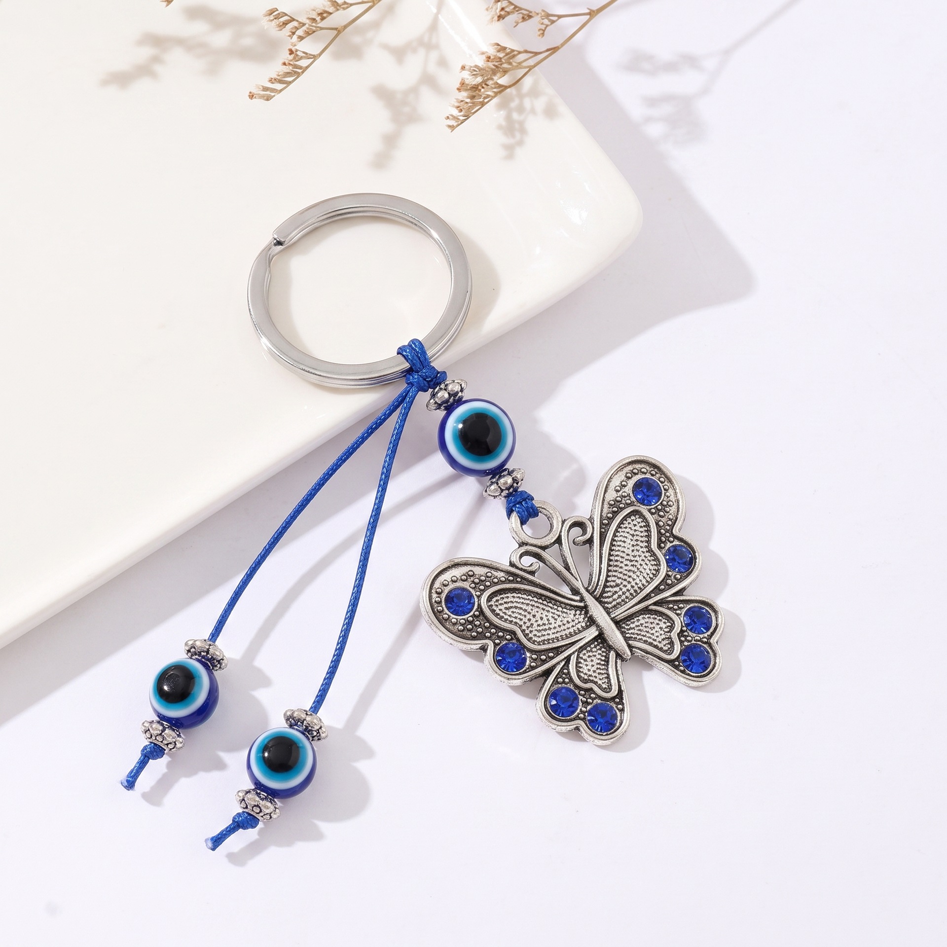 Nuevos colgantes de mariposa transfronterizos de aleación de ojos azules turcos bolsos colgantes de joyería