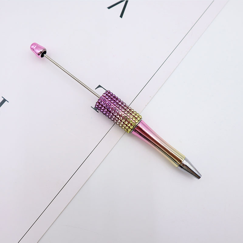 Bolígrafo giratorio de grano lindo de color degradado de tendencia de alto valor Bolígrafo de gomas galvanizado con cuentas de diamantes de bricolaje creativo