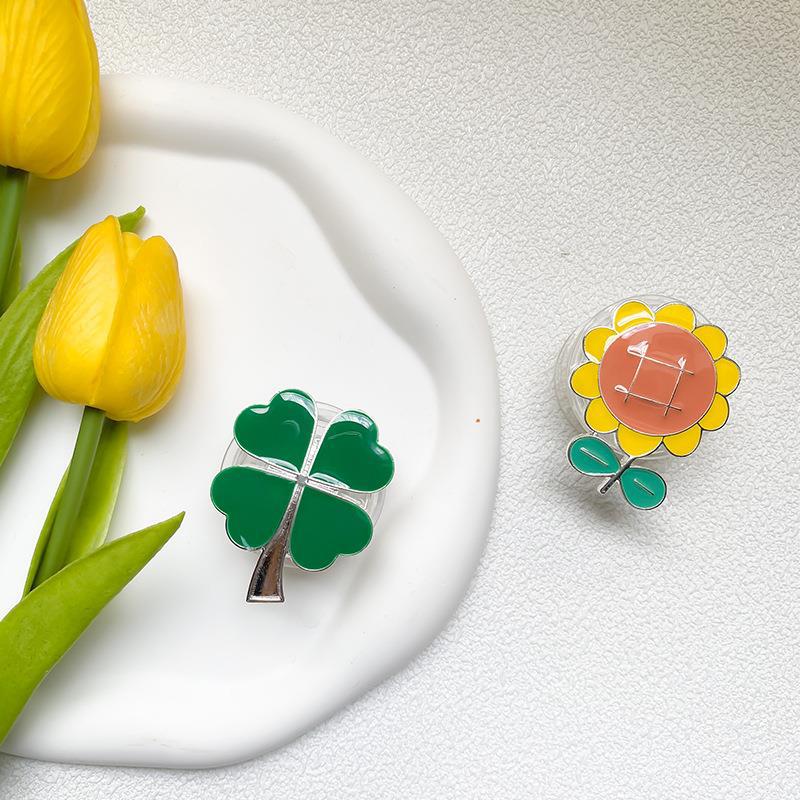 Instagram phone airbag with electroplated four leaf clover alloy sunflower desktop lazy support bracket on the back_voghion.com