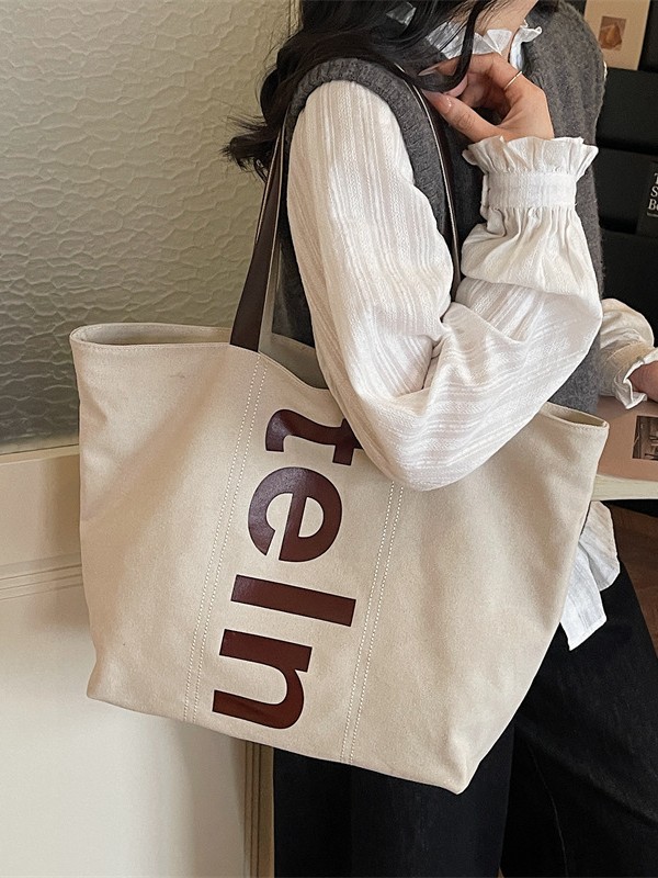 2026 nueva bolsa de hombro coreana versátil bolsa de lona casual para estudiantes universitarios de clase simple bolsa de viaje diario